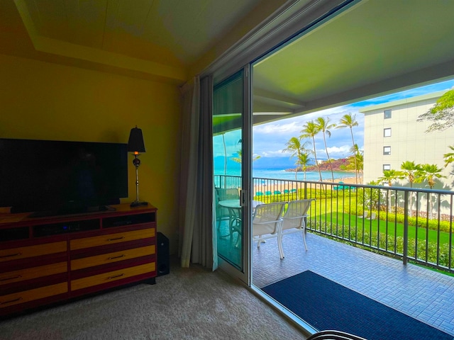 interior space featuring a water view and dark colored carpet