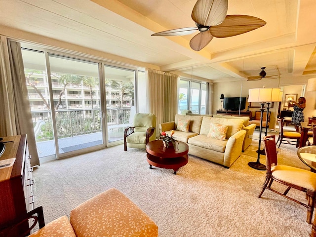 living room featuring beam ceiling, ceiling fan, and light colored carpet