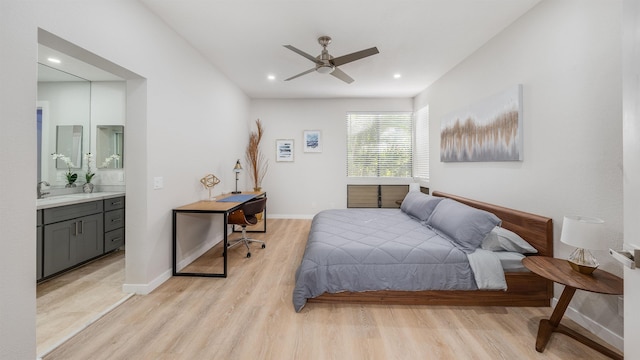 bedroom featuring sink, ceiling fan, connected bathroom, and light hardwood / wood-style floors