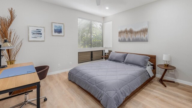 bedroom with ceiling fan and light hardwood / wood-style flooring