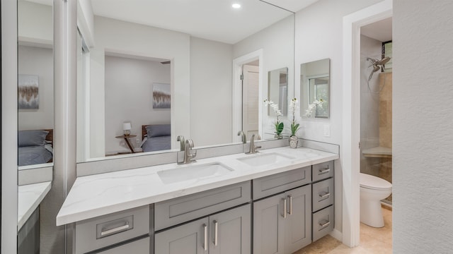 bathroom featuring toilet, vanity, and walk in shower