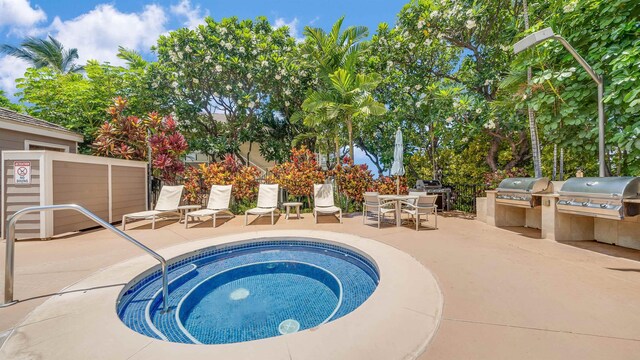 view of pool featuring a patio area, a community hot tub, exterior kitchen, and grilling area