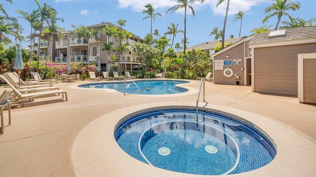 view of swimming pool featuring a patio area and a community hot tub