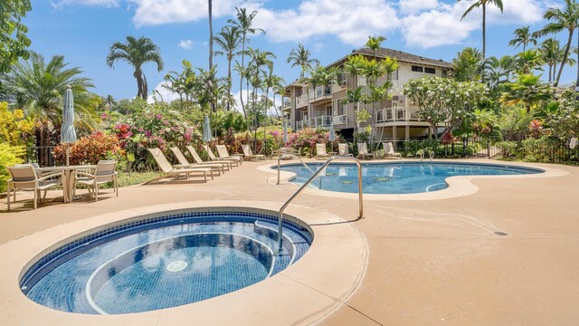 view of swimming pool featuring a patio area and a community hot tub