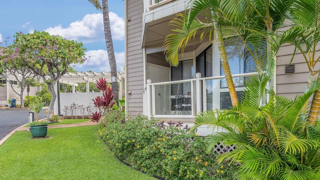 view of home's exterior featuring a lawn and a pergola