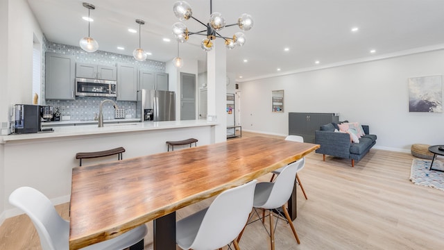 dining area featuring light hardwood / wood-style floors and sink