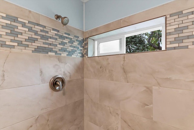 bathroom with a tile shower