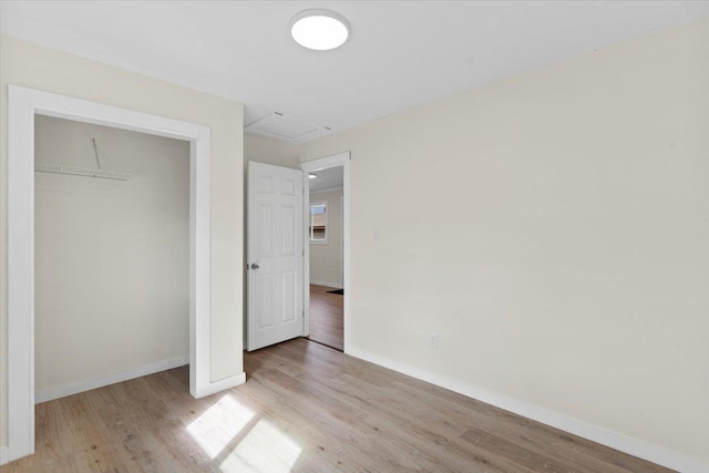 unfurnished bedroom featuring light hardwood / wood-style floors and a closet