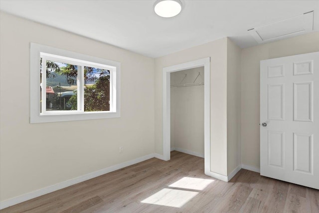 unfurnished bedroom with a closet and light hardwood / wood-style flooring