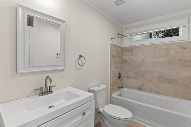 full bathroom featuring tiled shower / bath combo, toilet, and vanity