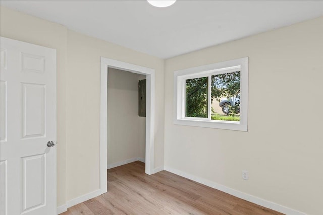 unfurnished bedroom with a closet and light hardwood / wood-style flooring