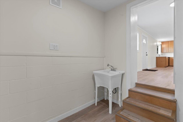 stairs featuring hardwood / wood-style floors