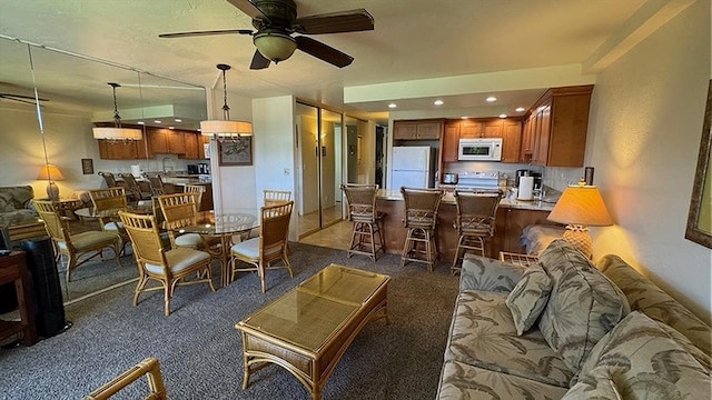 dining space featuring sink and light tile patterned flooring