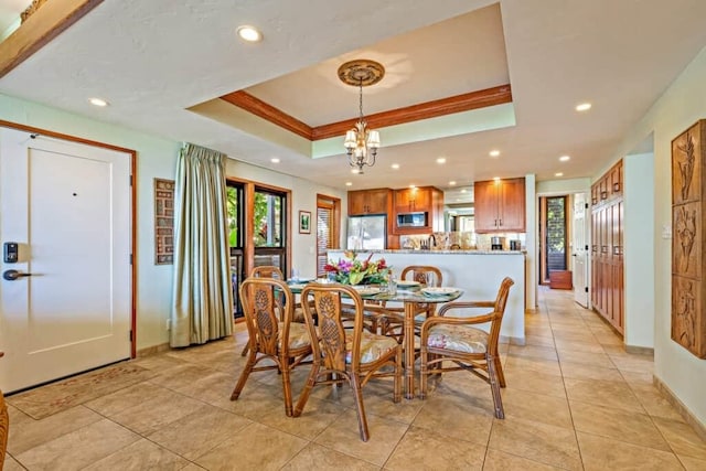 dining room featuring light tile patterned flooring, ornamental molding, a raised ceiling, and an inviting chandelier