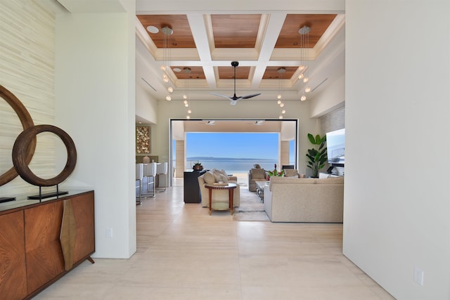 hall with a high ceiling, coffered ceiling, and beamed ceiling