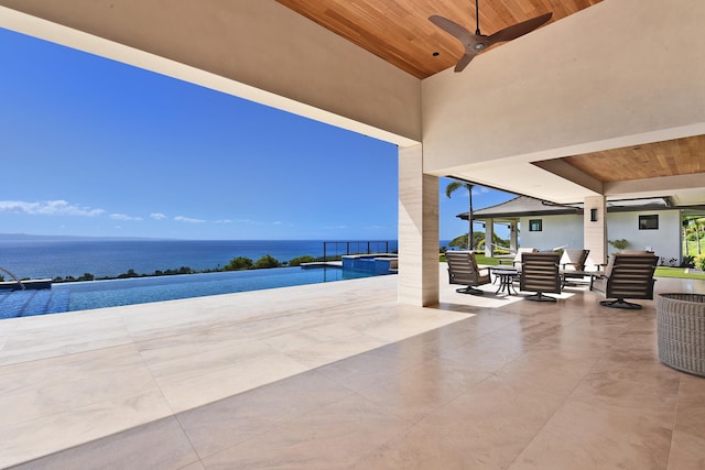 view of patio / terrace featuring a water view and ceiling fan