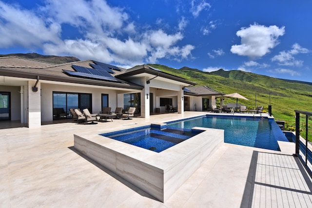 view of swimming pool featuring a mountain view and a patio