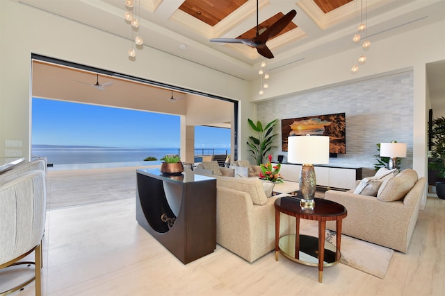 living room with beamed ceiling, coffered ceiling, light hardwood / wood-style flooring, a water view, and ceiling fan