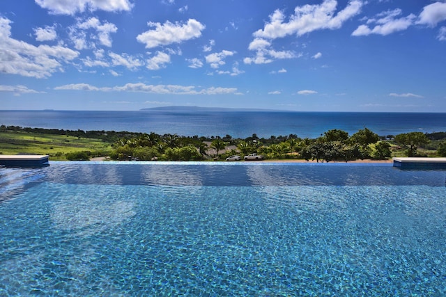 view of pool featuring a water view