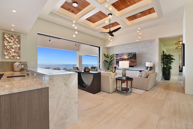 living room featuring wooden ceiling, beam ceiling, coffered ceiling, and sink