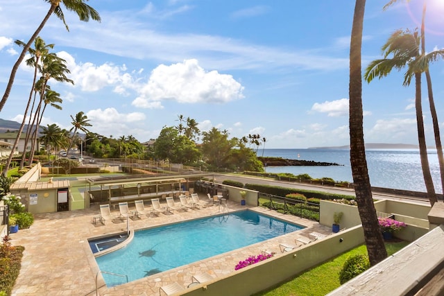 view of swimming pool with a water view and a patio