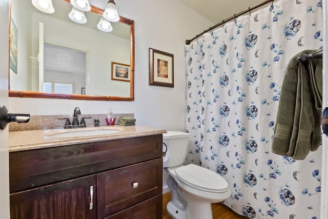 bathroom featuring a shower with curtain, vanity, toilet, and hardwood / wood-style floors