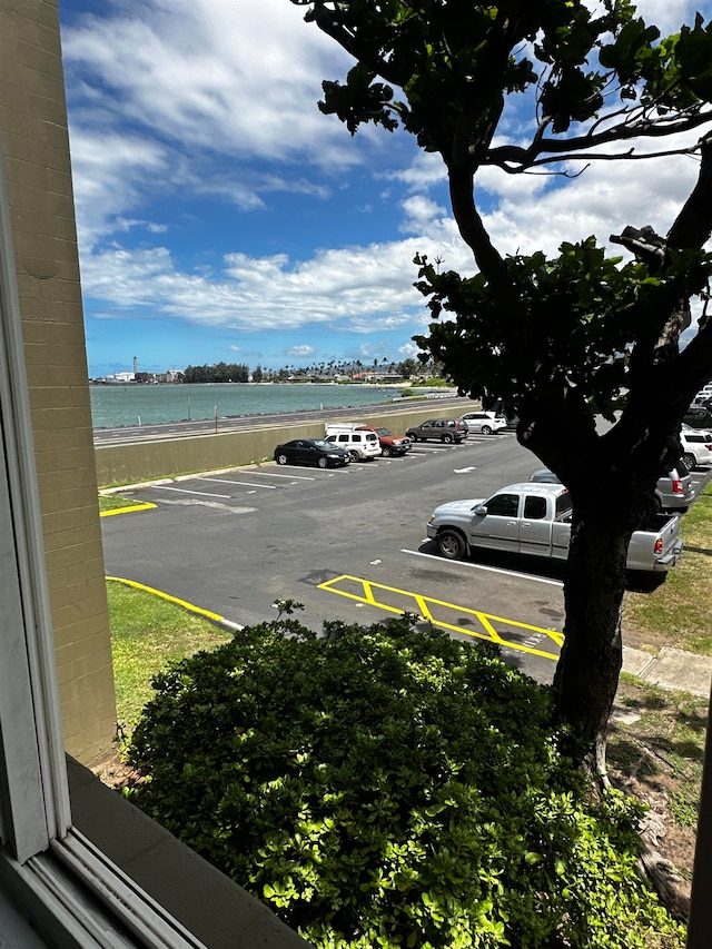 view of parking / parking lot featuring a water view