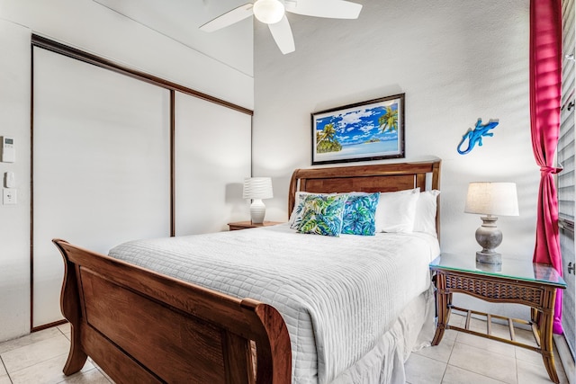 bedroom with ceiling fan, a closet, and light tile patterned floors