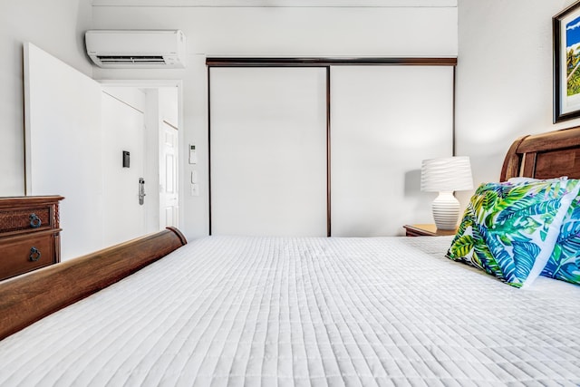 bedroom with a closet and a wall mounted AC