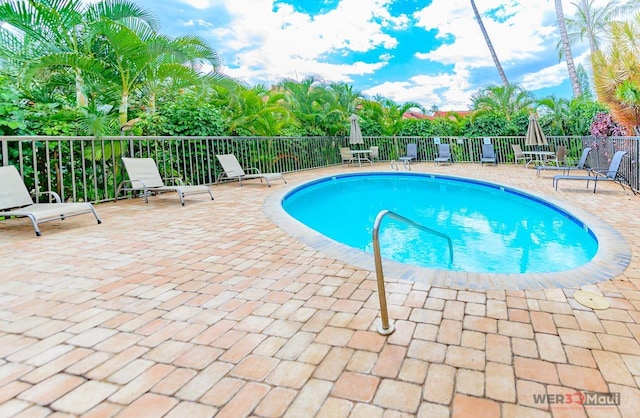 pool featuring a patio area and fence