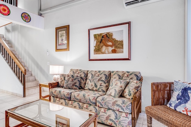 living area with tile patterned flooring, a wall unit AC, and stairway