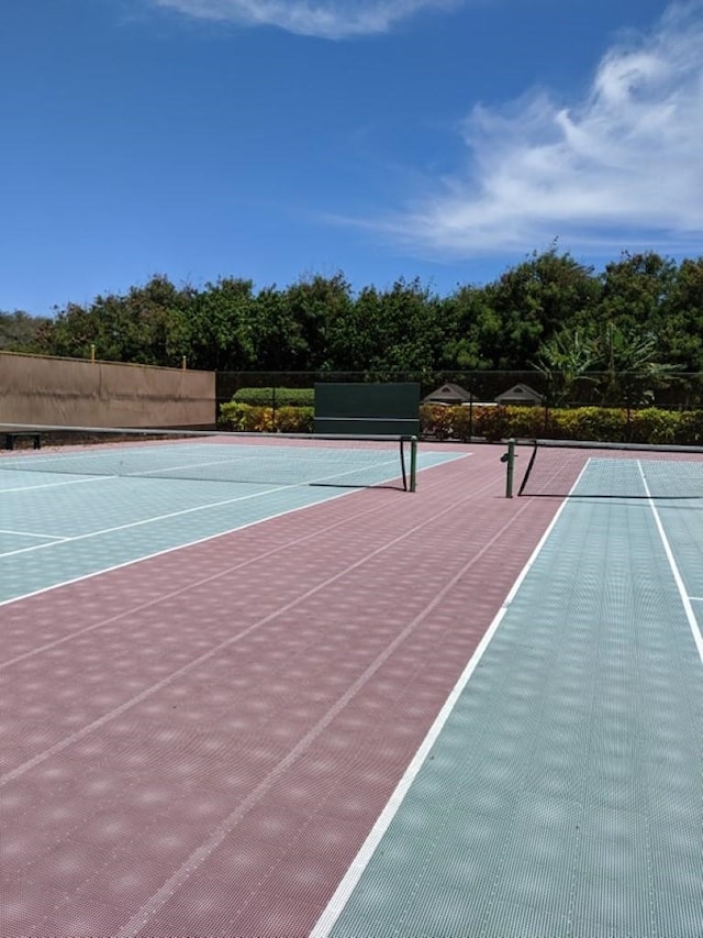 view of tennis court featuring basketball hoop