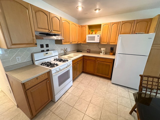 kitchen with light tile patterned floors, white appliances, tasteful backsplash, and sink