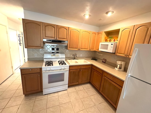 kitchen with decorative backsplash, sink, light tile patterned floors, and white appliances