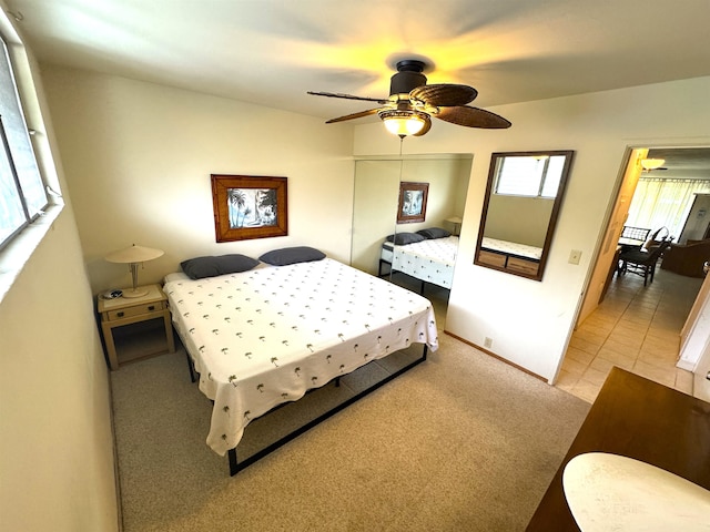 bedroom featuring light carpet and ceiling fan