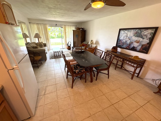 tiled dining area featuring a textured ceiling and ceiling fan