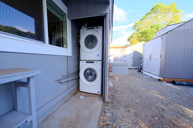 laundry area featuring stacked washer and dryer and laundry area