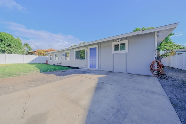 ranch-style home with a patio, a front yard, and a fenced backyard