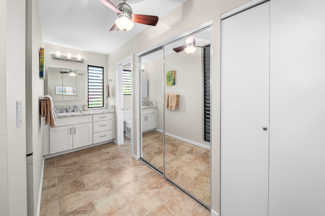 bathroom with ceiling fan, vanity, and toilet