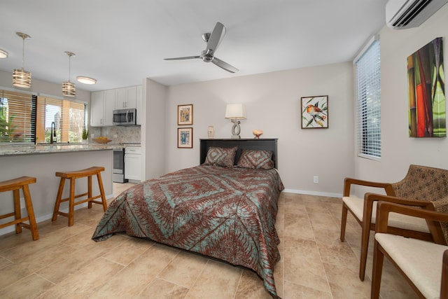 bedroom with ceiling fan, sink, and a wall mounted air conditioner