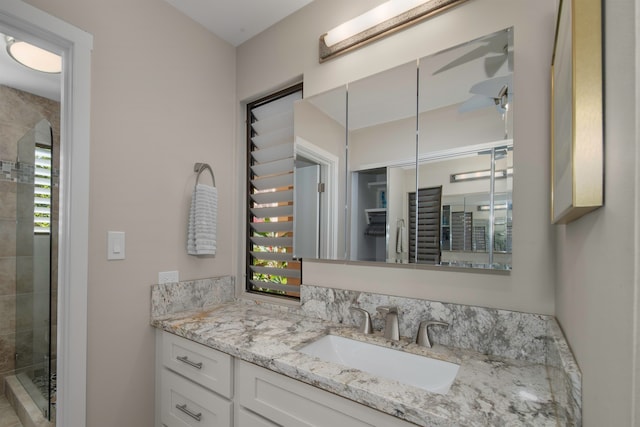 bathroom featuring walk in shower and vanity