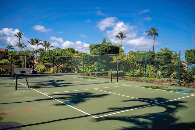 view of tennis court with basketball hoop