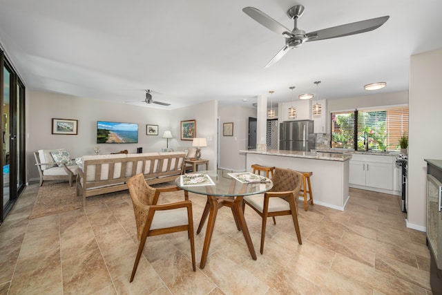 dining room with ceiling fan and sink