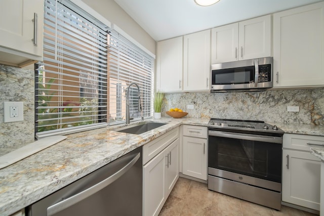 kitchen featuring white cabinets, appliances with stainless steel finishes, and sink