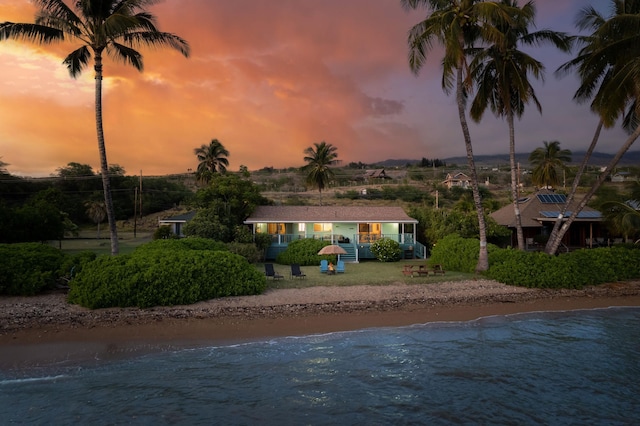 exterior space with a water view and a view of the beach