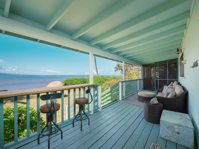 deck featuring a water view and a view of the beach