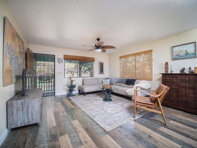 living room with ceiling fan and dark hardwood / wood-style floors