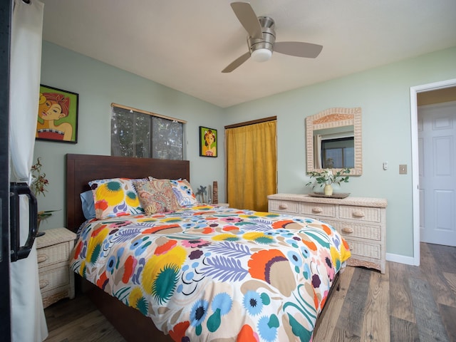 bedroom with ceiling fan, a closet, and dark wood-type flooring