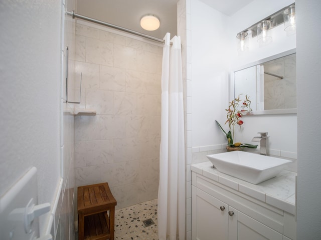 bathroom featuring a shower with curtain, vanity, and tile walls