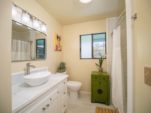 bathroom featuring vanity, curtained shower, and toilet